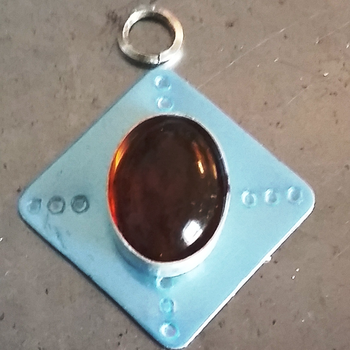 Handmade sterling silver bezel set amber pendant configuration