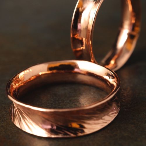 Handcrafted recycled copper anticlastic rings