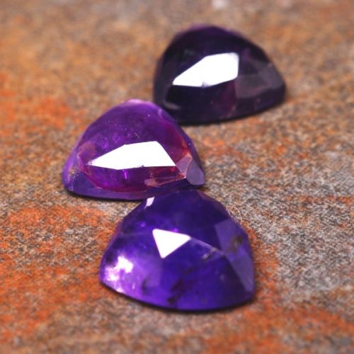 Faceted triangular amethyst cabochons